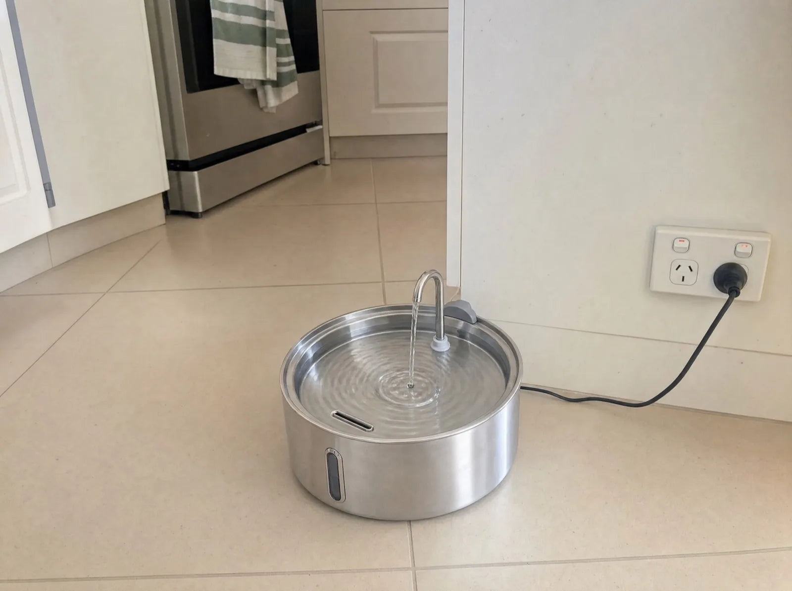 The Fresh Flow stainless steel dog fountain running on kitchen tiles
